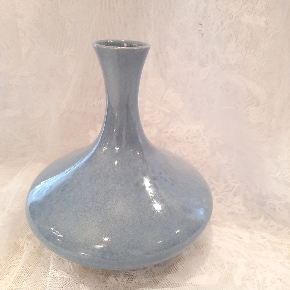 Light blue ceramic vase with natural shades of white/darker blue